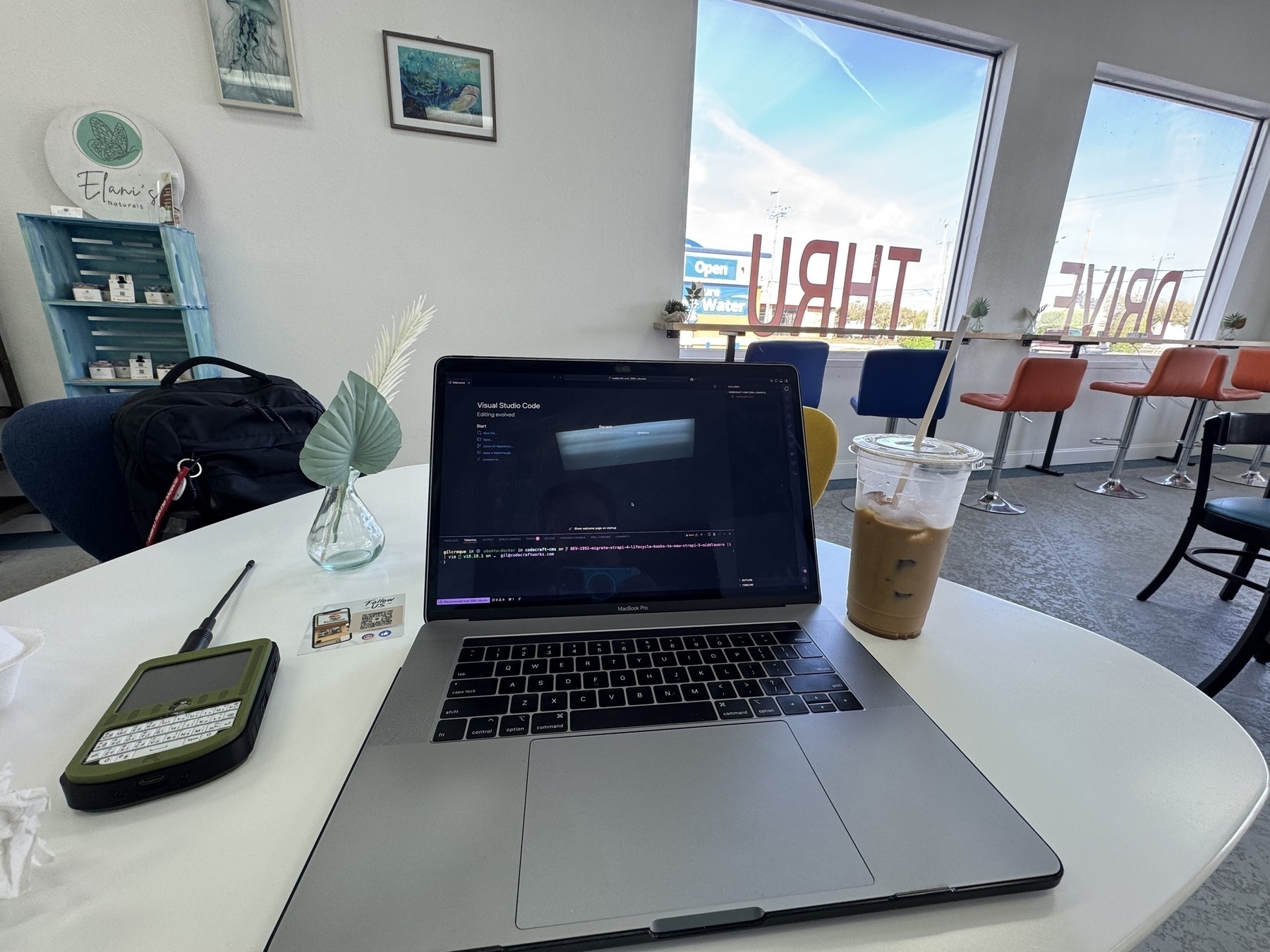 Laptop and coffee on table in coffee shop
