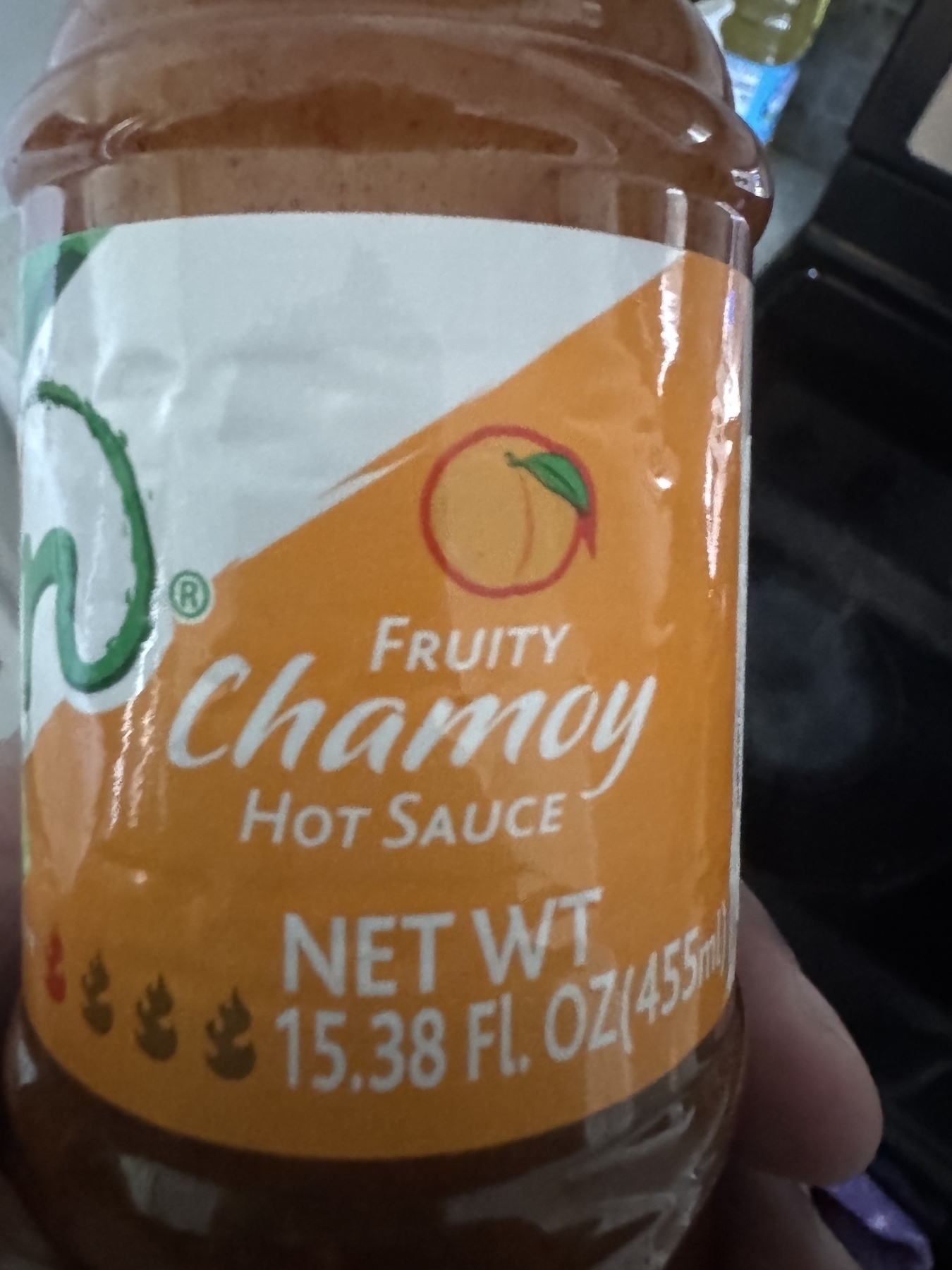 A bottle of fruity chamoy hot sauce with a net weight of 15.38 fluid ounces (455 ml) is shown.